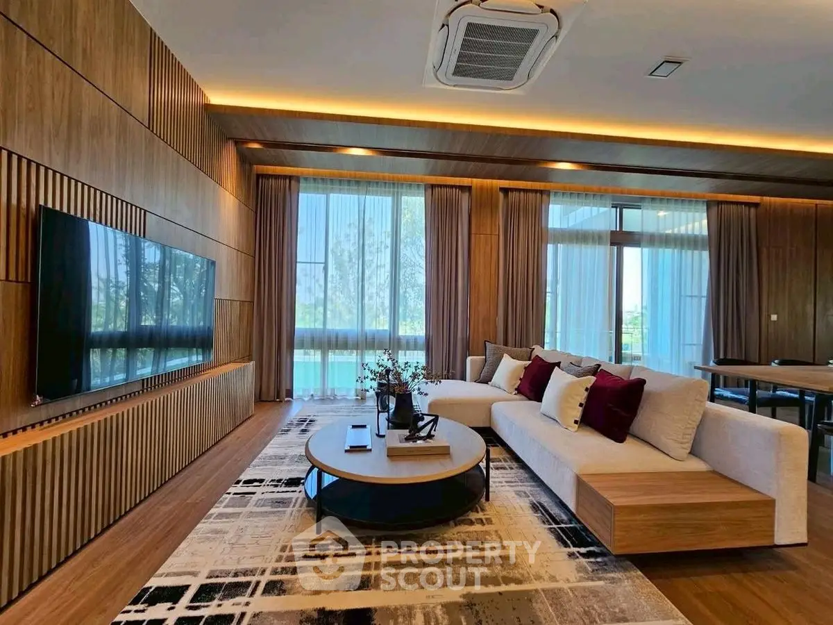 Luxurious modern living room with elegant wooden paneling and large windows offering stunning views.