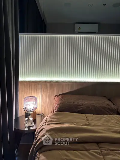 Cozy bedroom with modern lighting and elegant decor, perfect for relaxation and comfort.