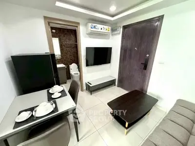Modern compact living room with dining area and bathroom access