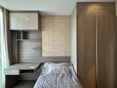 Modern bedroom with stylish wood paneling and built-in desk, perfect for urban living.