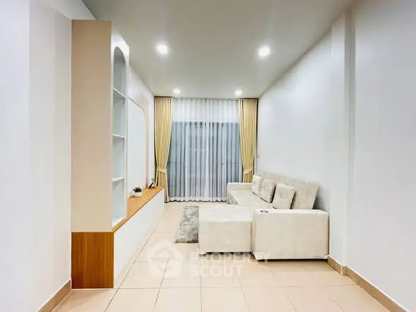Modern living room with elegant white sofa and stylish shelving