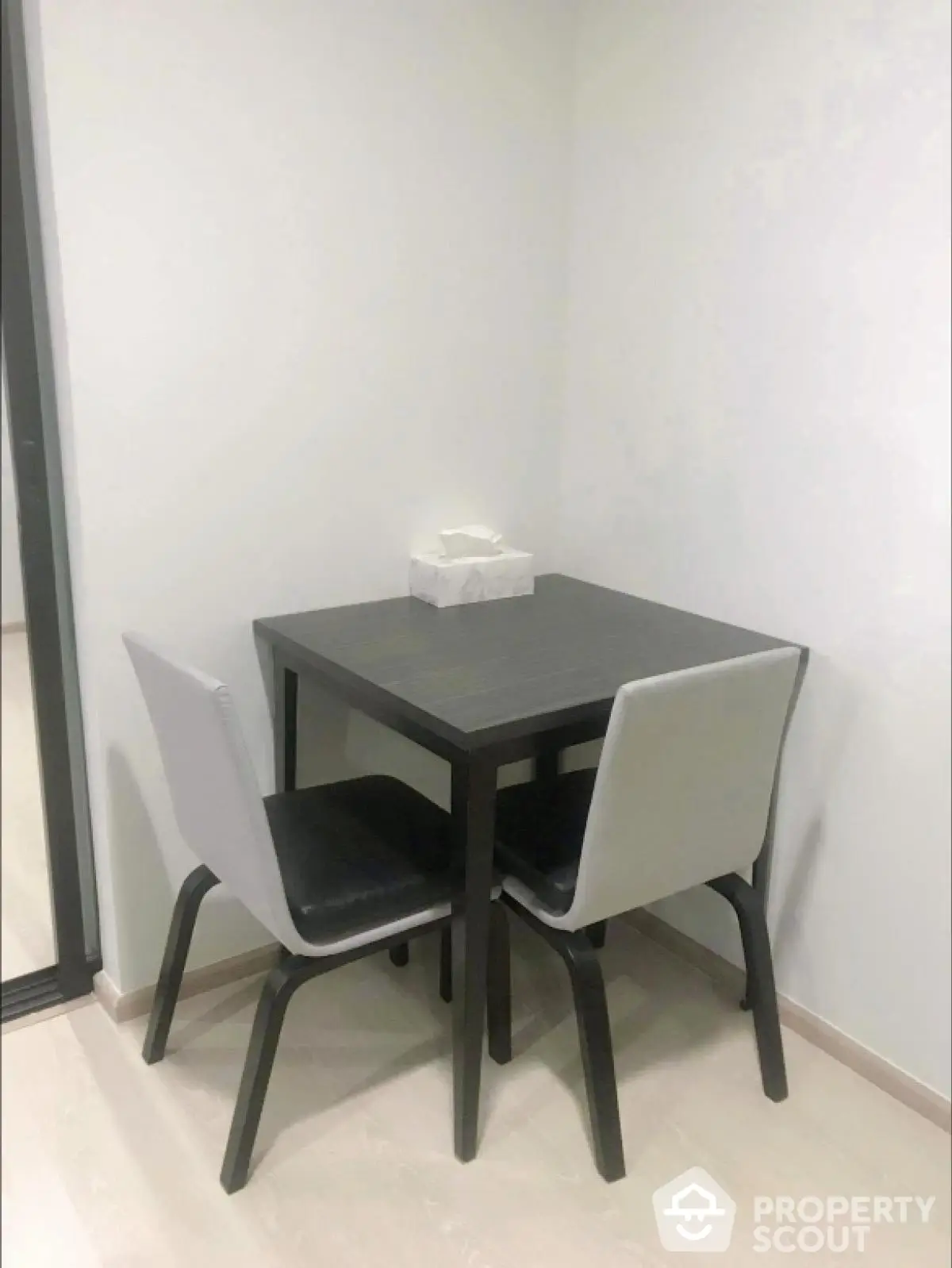 Cozy dining nook with modern table and chairs in minimalist apartment