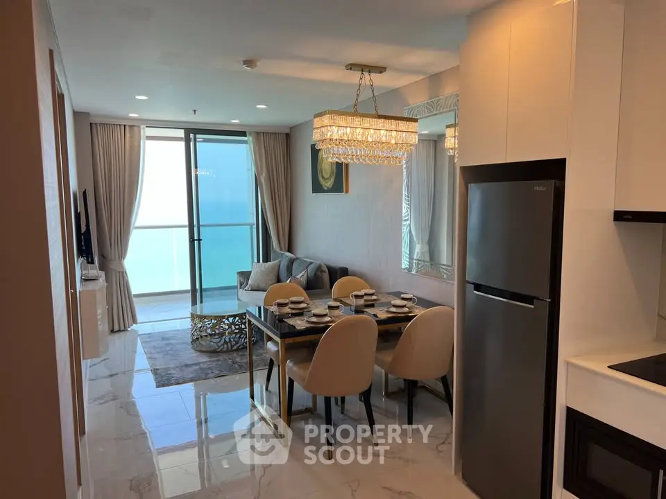 Luxurious modern living room with dining area and ocean view balcony