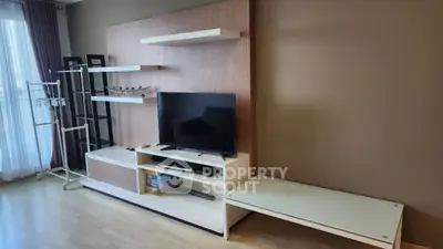 Modern living room with sleek TV stand and stylish shelving, perfect for contemporary living.