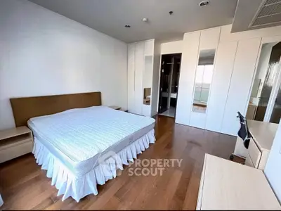 Spacious bedroom with modern design and ample storage in a luxury apartment.