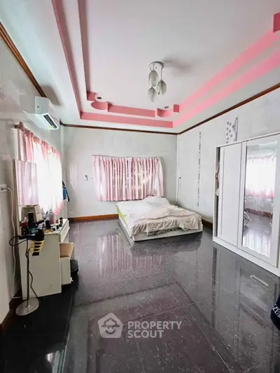 Spacious bedroom with modern design and ample natural light