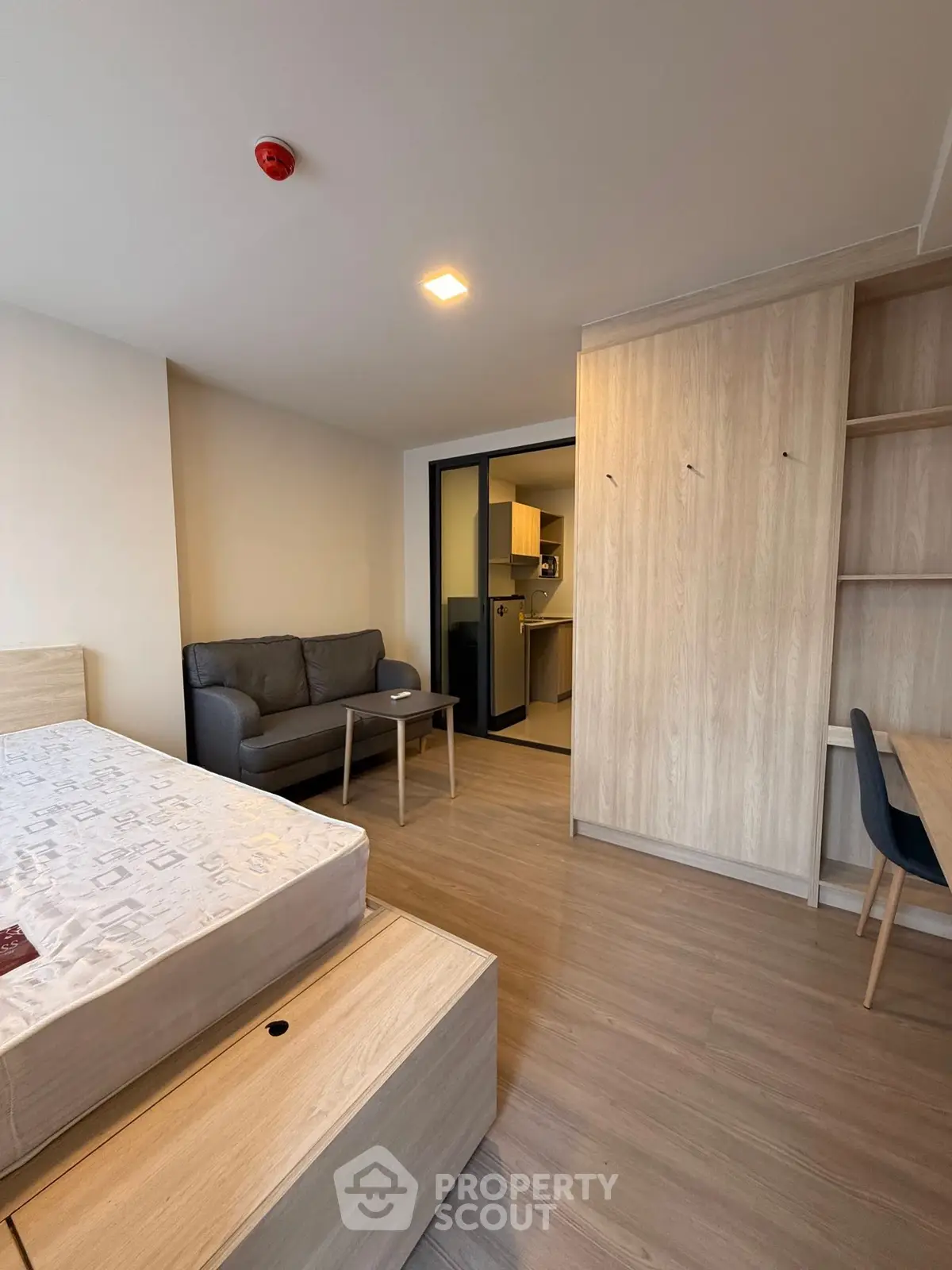 Modern studio apartment with cozy living area and compact kitchen