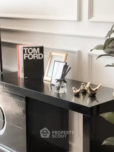 Elegant interior decor with black console table and stylish accessories in modern living space.