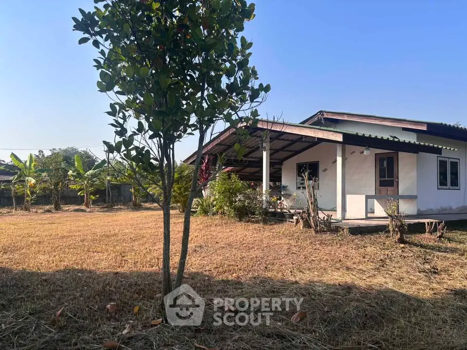 Charming single-story home with spacious yard and covered patio, perfect for outdoor living.