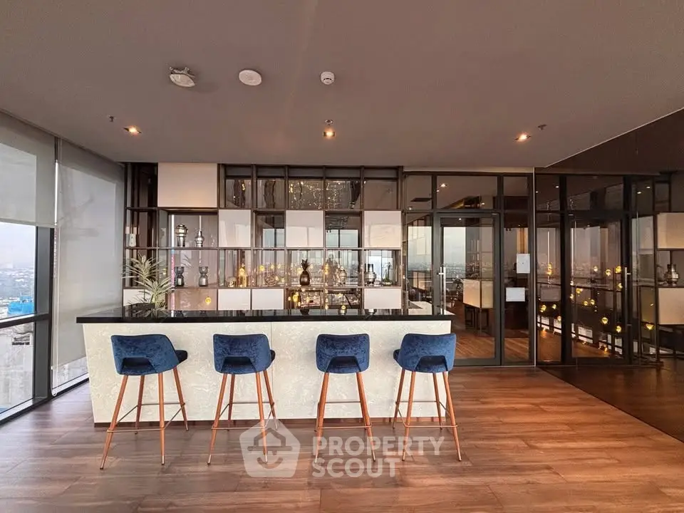 Luxurious modern living room with stylish bar area and panoramic city views.