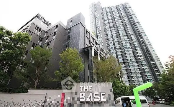 Modern high-rise condominium with sleek design and lush greenery at The Base.