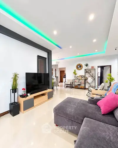 Spacious modern living room with sleek design and ambient lighting