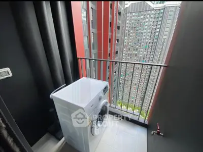 Modern high-rise balcony with washing machine and city view
