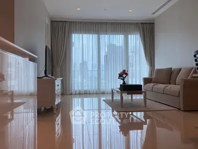 Spacious living room with elegant decor and city view through large windows.