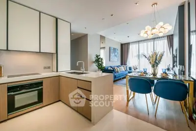 Modern open-plan kitchen and living room with stylish decor and ample natural light.