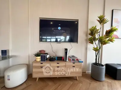 Modern living room with stylish TV setup and wooden cabinet