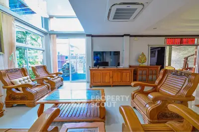 Spacious living room with elegant wooden furniture and large windows