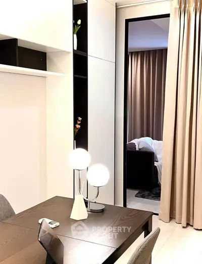 Modern apartment interior with stylish dining area and cozy living room view.