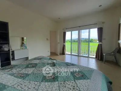 Spacious bedroom with balcony offering stunning countryside views