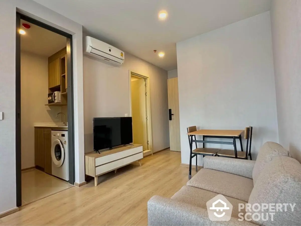 Modern living room with washing machine and air conditioning in cozy apartment