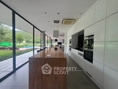 Luxurious modern kitchen with sleek design and stunning garden view