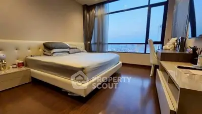 Luxurious bedroom with stunning city view and elegant furnishings.