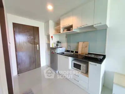 Modern kitchen with sleek cabinetry and built-in appliances in a stylish apartment.