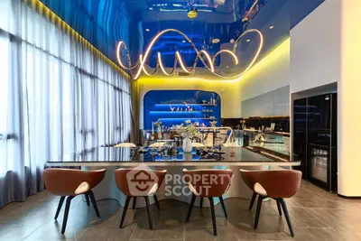 Luxurious modern kitchen with sleek design and stylish lighting, featuring a spacious island and elegant seating.