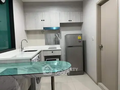Modern kitchen with sleek cabinetry and appliances in compact layout