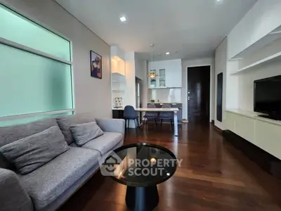 Modern living room with sleek furniture and open kitchen layout