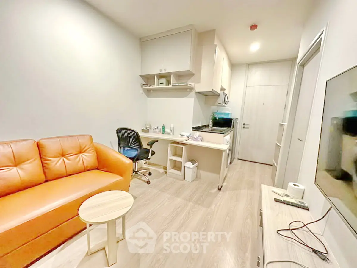 Modern studio apartment with cozy living area and compact kitchen