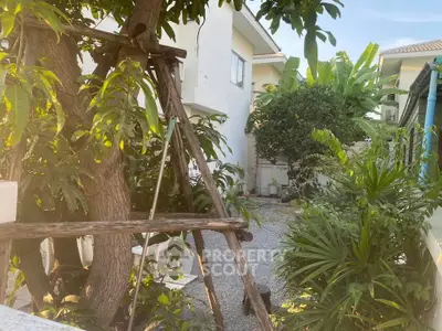 Charming garden view with lush greenery and residential building exterior.