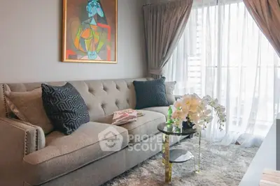 Stylish living room with modern art, plush sofa, and elegant decor in a bright apartment.