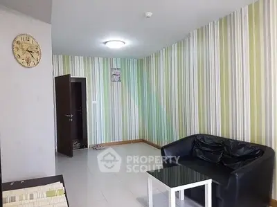 Modern living room with striped wallpaper and sleek black sofa