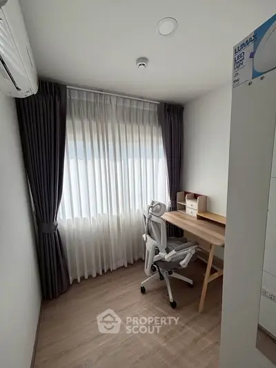 Modern study room with ergonomic chair and desk, featuring large window with elegant curtains.