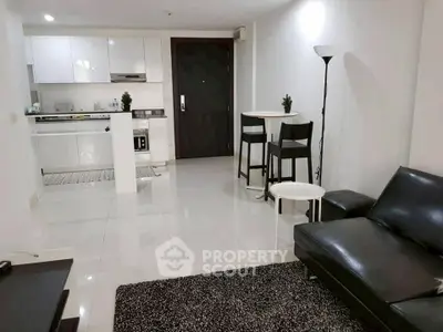 Modern open-layout living room with sleek kitchen and stylish furniture