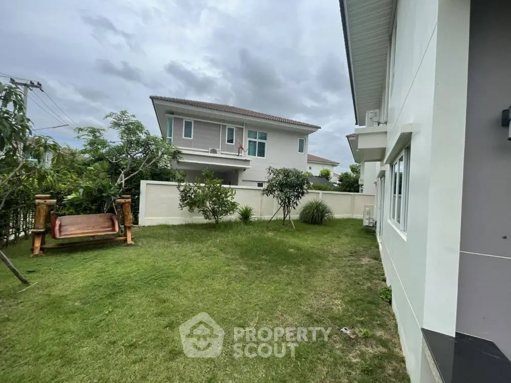 Spacious garden area with modern house exterior, perfect for outdoor relaxation.