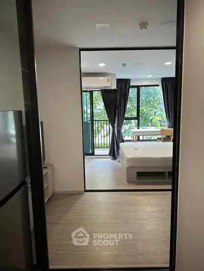 Modern bedroom with balcony view and natural light