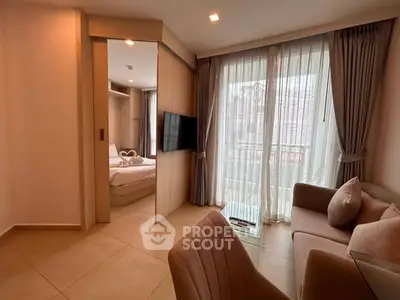Modern apartment interior with cozy living room and bedroom, featuring elegant furniture and large windows.