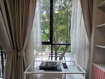 Charming study nook with large window and lush garden view, perfect for inspiration and productivity.