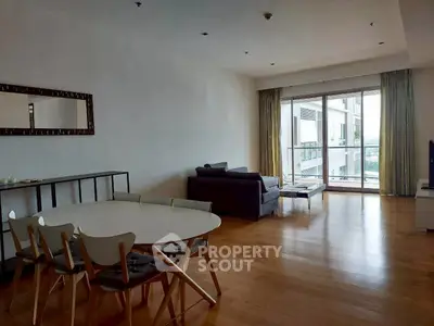 Spacious living room with modern furniture and large window offering natural light.
