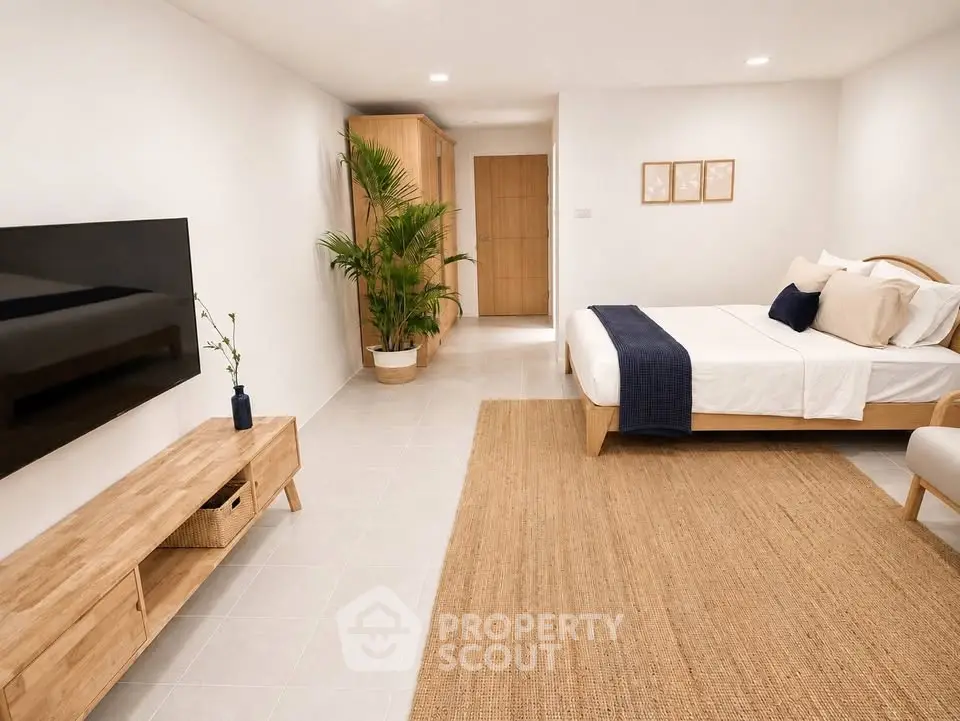 Spacious modern bedroom with minimalist decor and wooden furniture