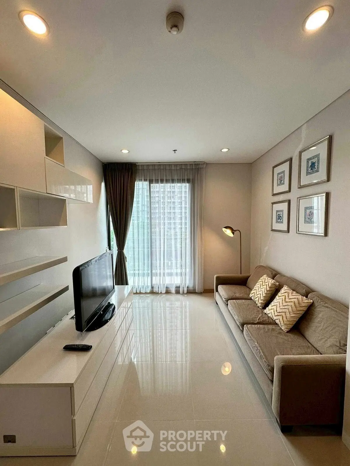 Modern living room with sleek design, cozy sofa, and large window for natural light.
