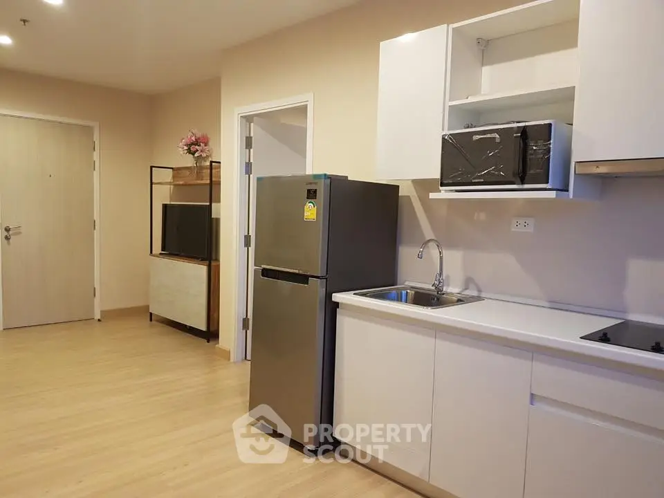 Modern kitchen with sleek appliances and open layout in a stylish apartment.