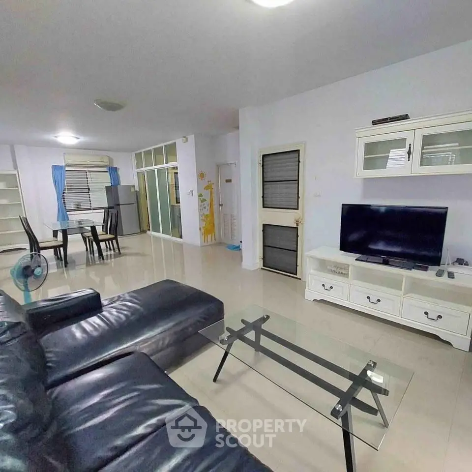 Spacious living room with modern furniture and glass coffee table