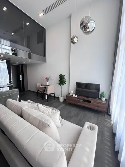 Luxurious modern living room with high ceilings and elegant decor in a stylish apartment.