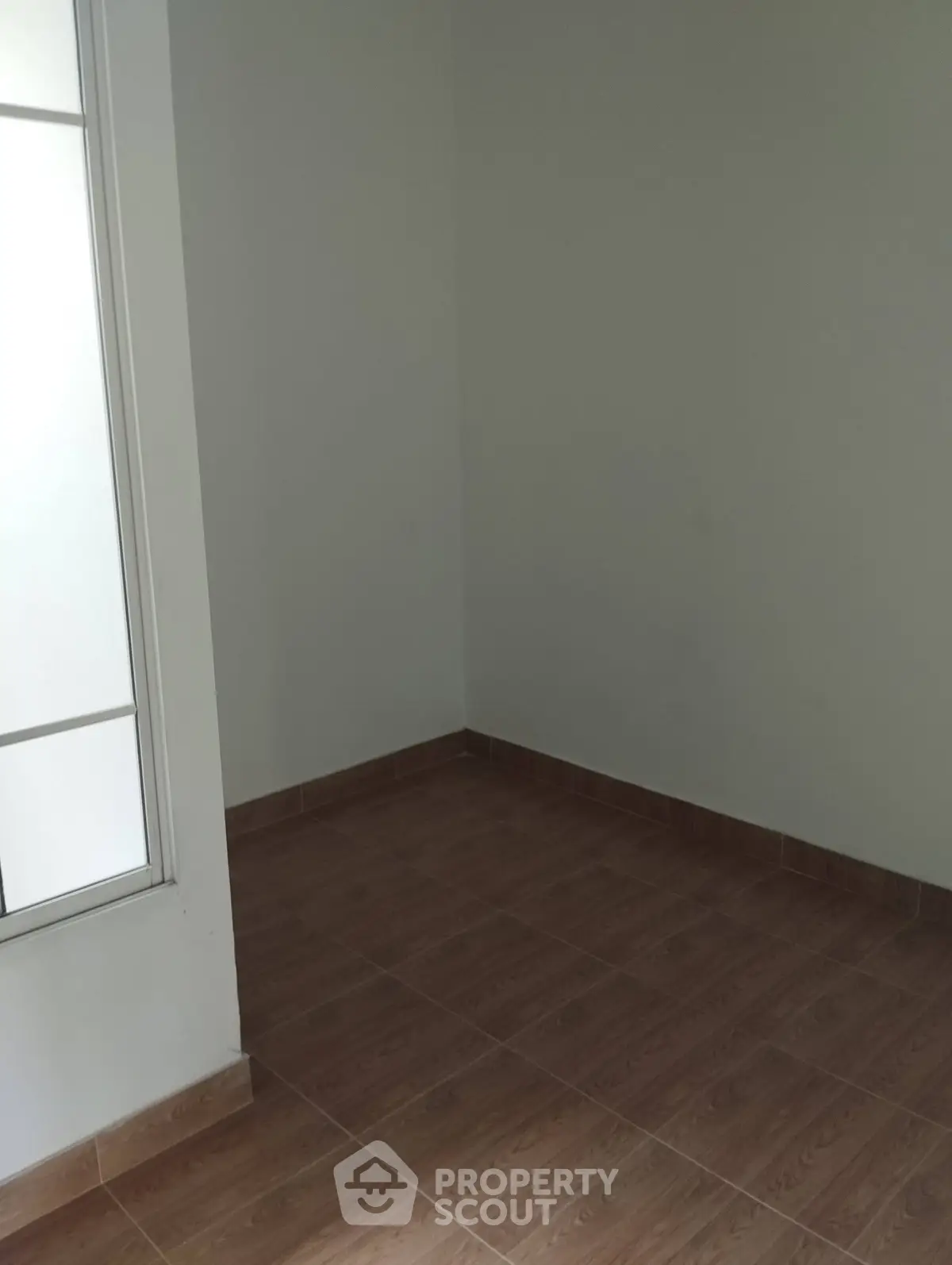 Minimalist empty room with tiled floor and natural light, perfect for customization.