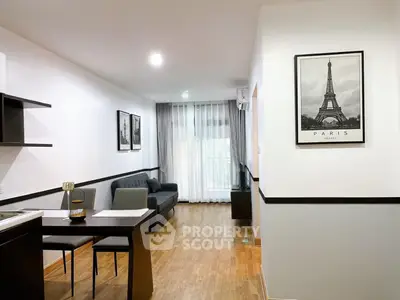 Modern living room with stylish decor and wooden flooring in a cozy apartment.