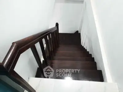 Elegant wooden staircase with polished finish in modern home interior