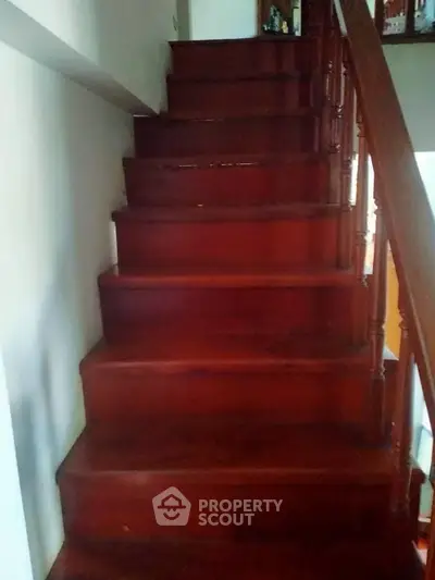 Elegant wooden staircase with polished finish in a cozy home interior.